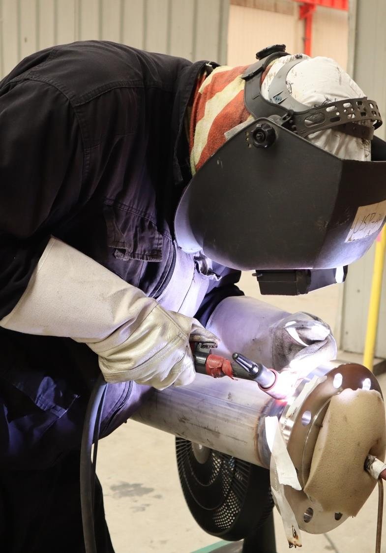 Welder working on a pipe spool